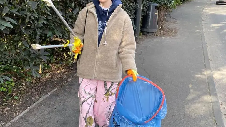 Young person picking up rubbish