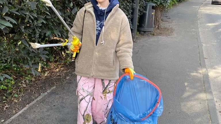 Young person picking up rubbish