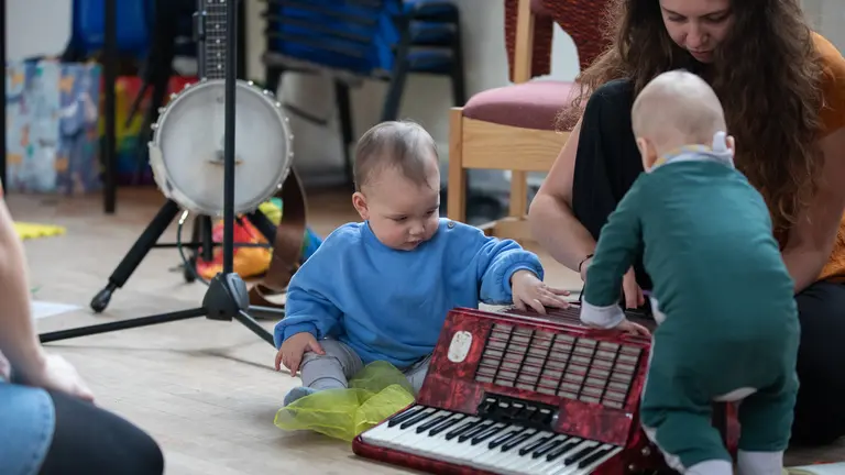 two babies playing musical instruments