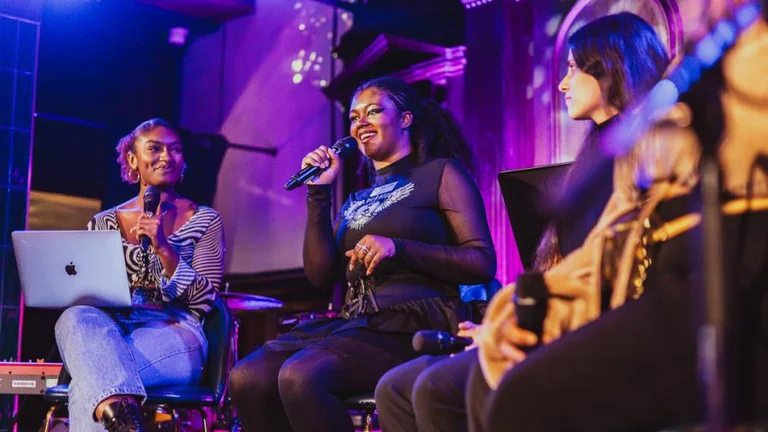 Panel discussion with one person holding the microphone and speaking