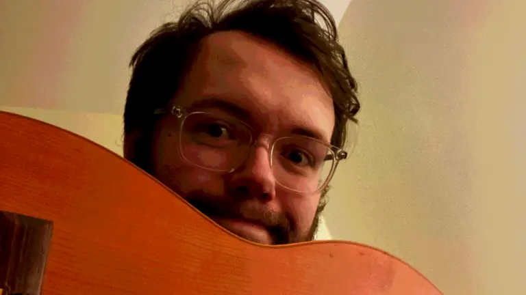 peter holds a guitar