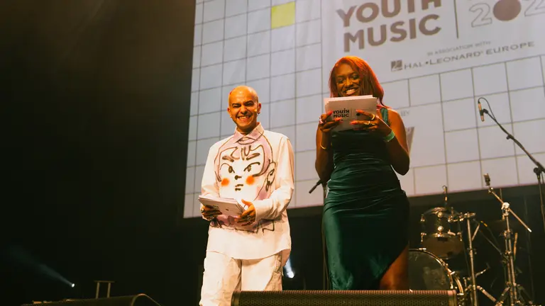 benny and nieema stand on stage at the youth music awards 2022