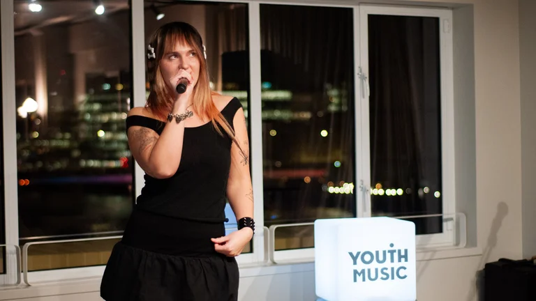 coupdekat performs in a black dress