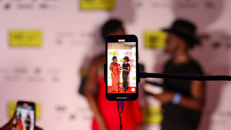 Image of a phone screen taking a picture of youth music awards