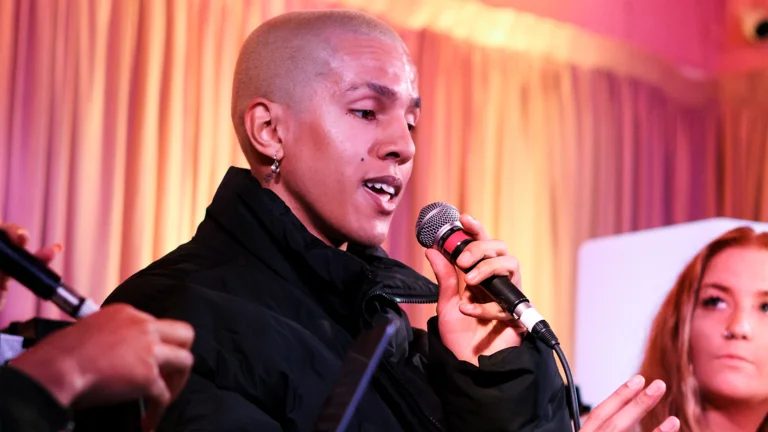 a person holds a microphone and speaks 