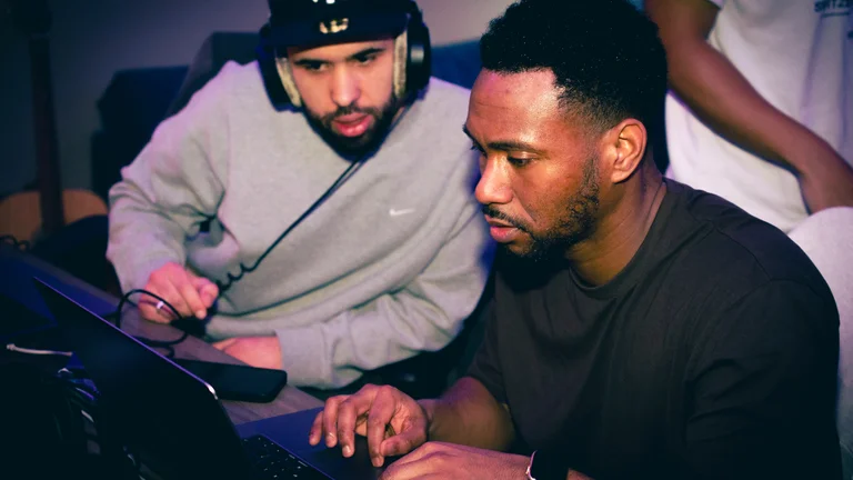 two men work on production