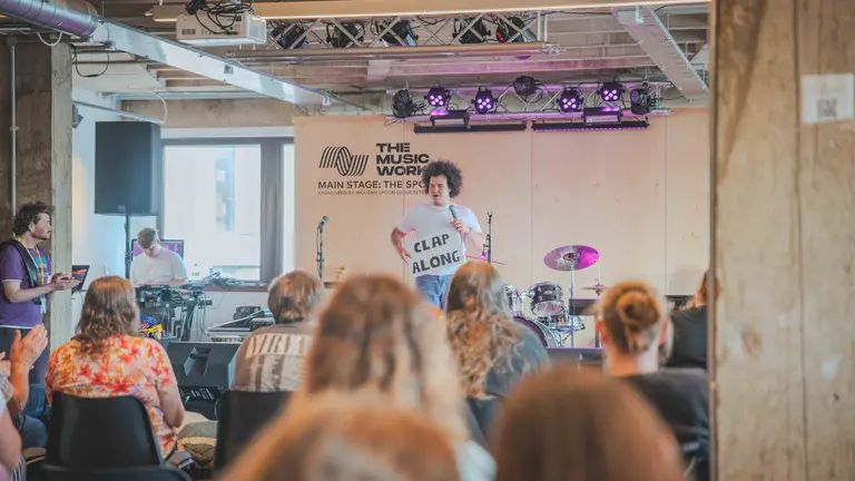 Image of Mackenzie leading a music project