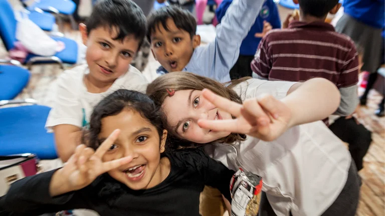 four children smile and pose for the camera