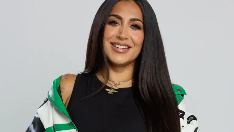 image of ellie prohan, jacket off one shoulder and smiling