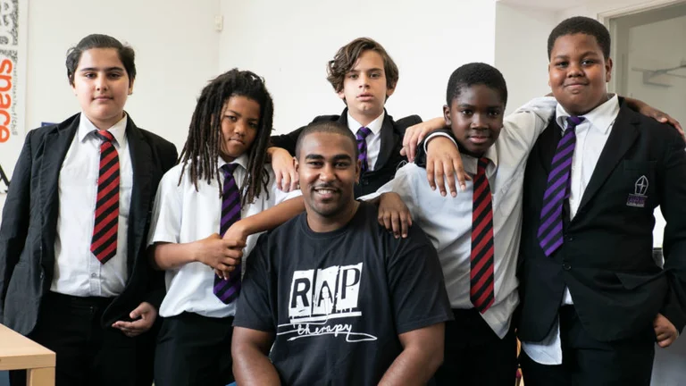 Rap Therapy CEO with five young people behind