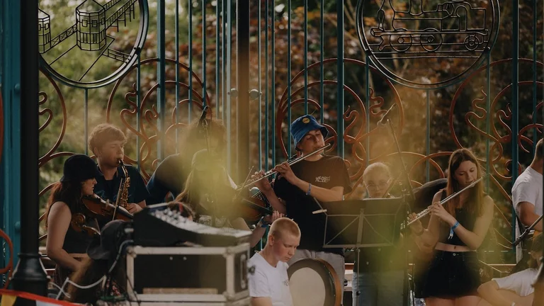 Seven young people playing different instruments in a band