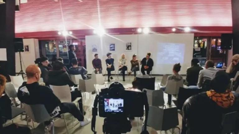 Panel of five people with audience