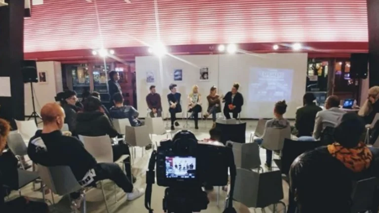 Panel of five people with audience
