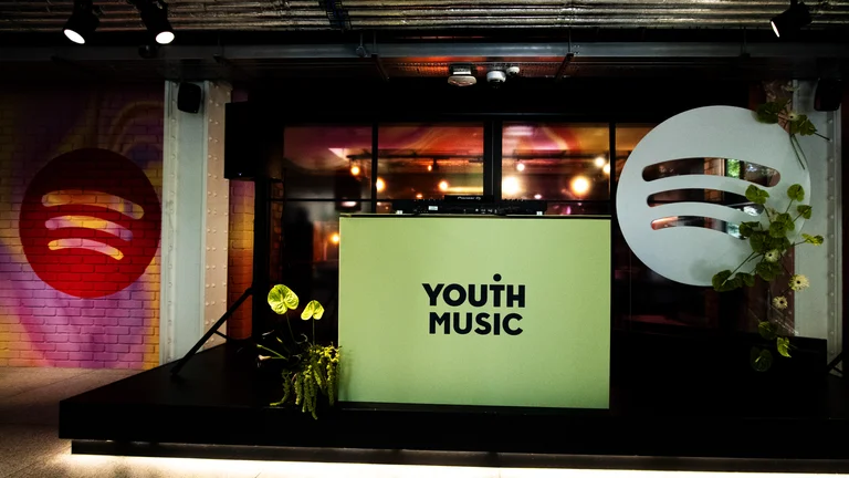 image of the Youth Music logo in spotify green and the spotify logo in Spotify HQ