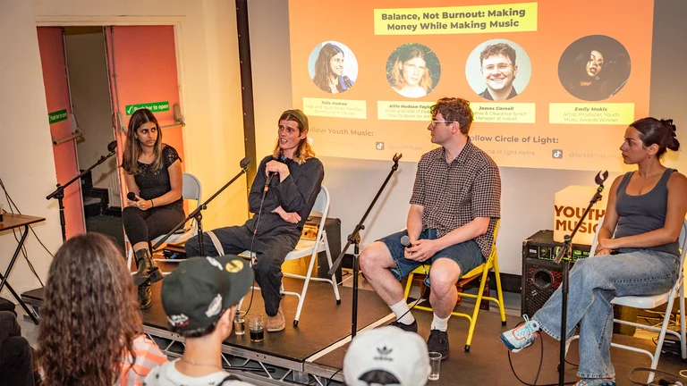 a group of people sit on a panel