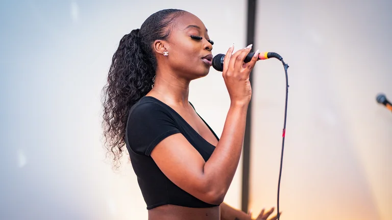 a woman sings into a mic