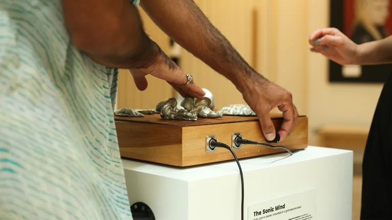 hands play with an instrument called the sonic mind
