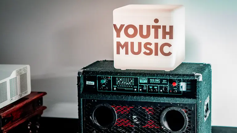 Youth Music branded lightbox sat on an amp