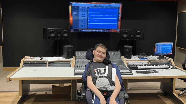 Adrian (DJ Dobra) sat on a chair in his studio