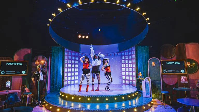 three performers on a circular stage