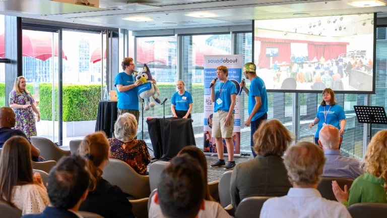 soundabout session run by the team on a stage wearing blue tops in front of an audience