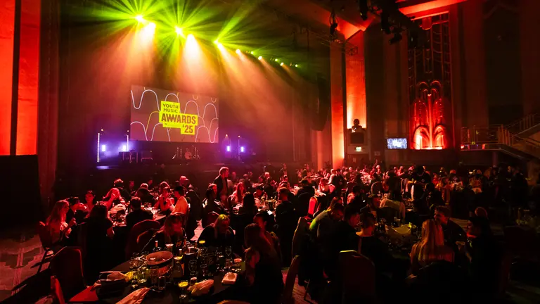an image of the youth music awards stage 2025 with the guests at round tables