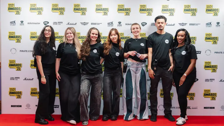 nextgen team at the ymas2025 posing for a photo in black Youth Music t-shirts