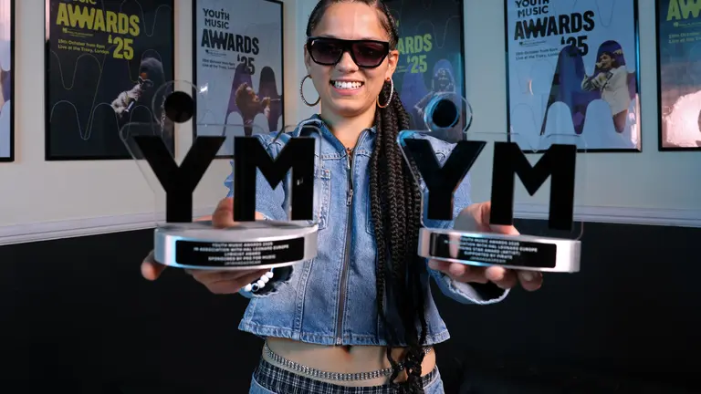 JAYAHADADREAM holding two awards, sunglasses on and smiling