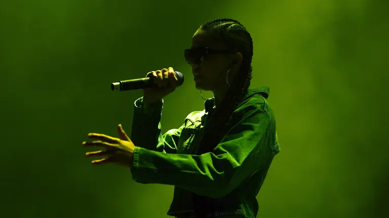 Jayahadadream performing at the YMAs 2025 surrounded in dry ice that is lit up in green