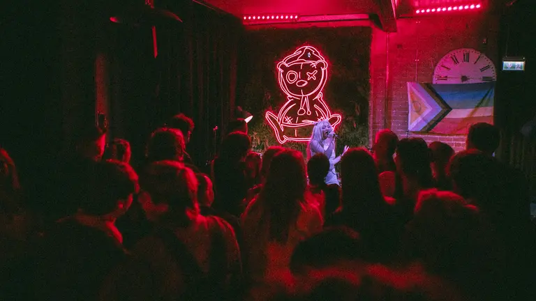 a person performs on stage in a red room