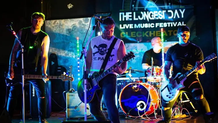 a band plays on stage at the longest day festival