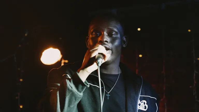 c4truth sings into a microphone