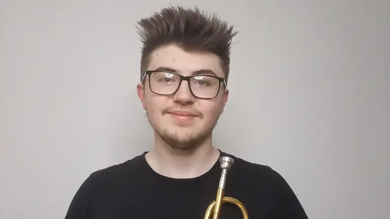 ethan wears glasses and a black t shirt