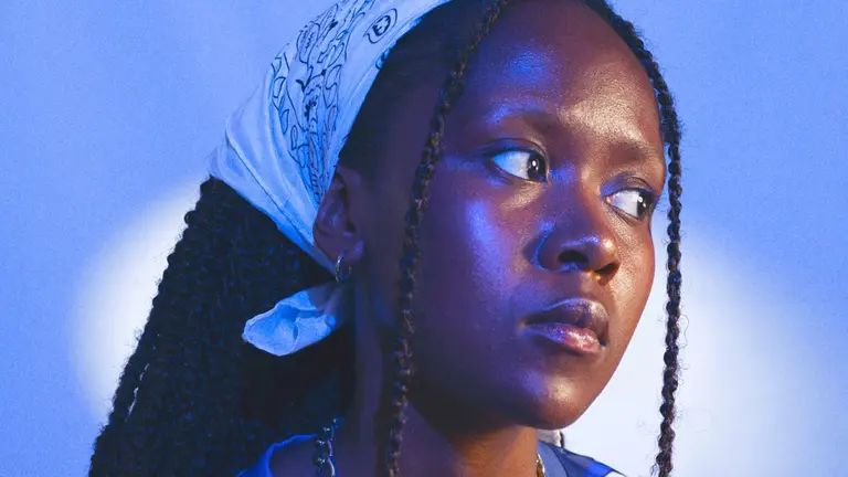 a woman wears a headband and looks to the side