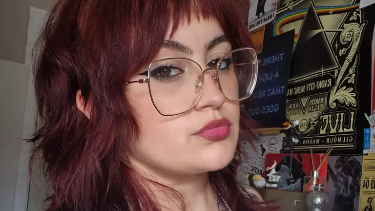 a woman with red hair and glasses