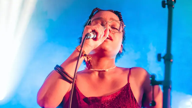 rhaine sings into a mic