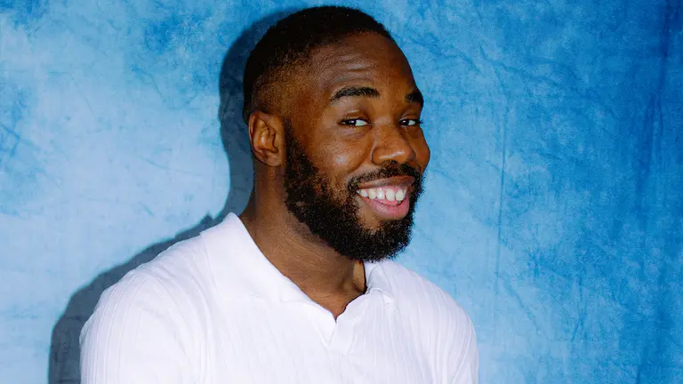 a man with a beard smiles