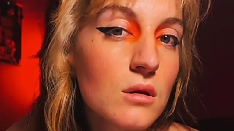 a woman with blonde hair has striking eye makeup