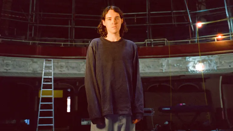 a man stands in an auditorium