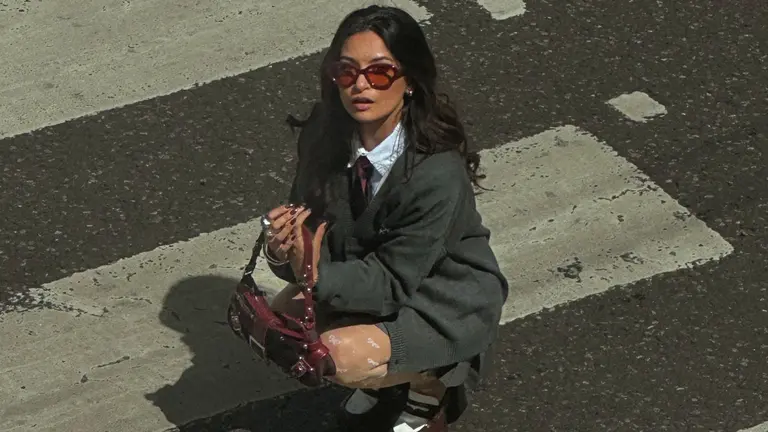 a woman crouches on a crossing