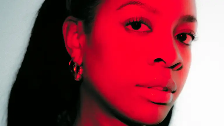 a person's face is bathed in red light