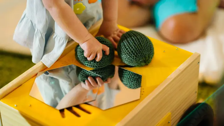 child playing with toys wearing blue 