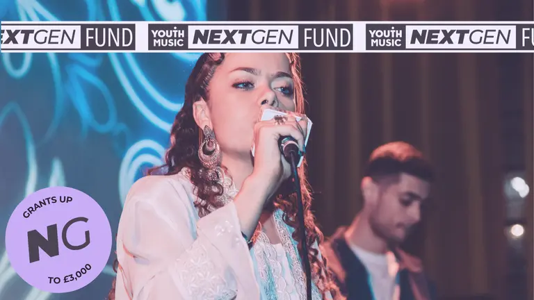 A performer sings on stage in front of colourful lighting, with NextGen Fund and Youth Music branding across the top and a circular badge showing grants of up to £3,000.