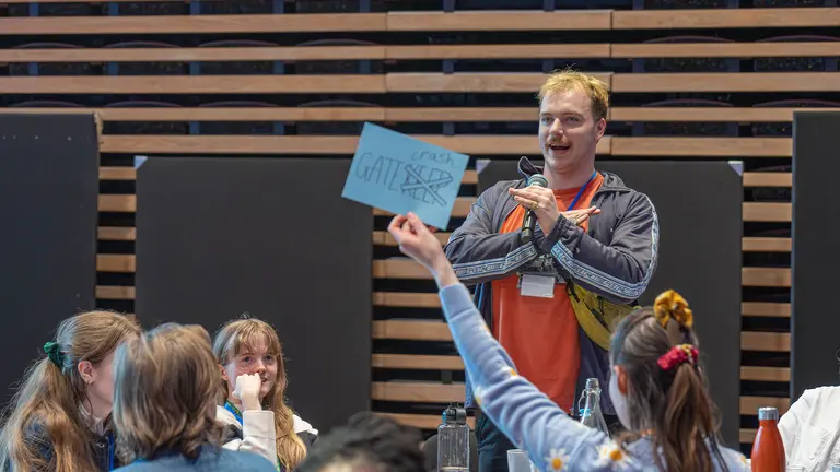 a person raises a blue note in the air