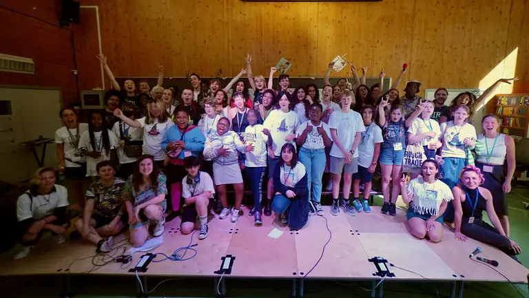 a large group of young women pose for a team photo