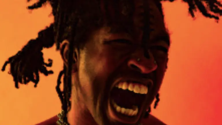 FREDDIE screaming infront of a dark yellow and red background