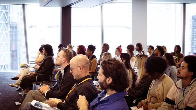 a busy room full of seated people