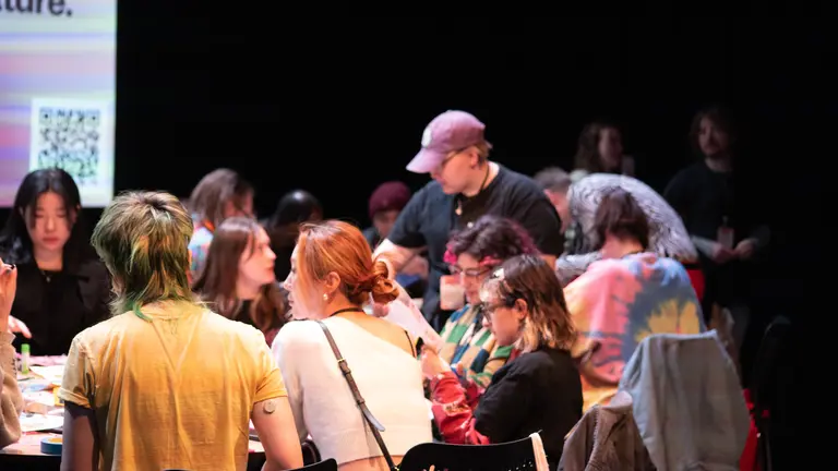 Group of young people in a round table with facilitator