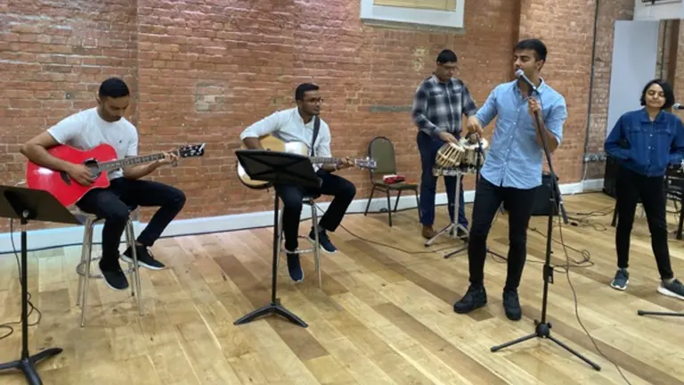 A band of five young people playing instruments