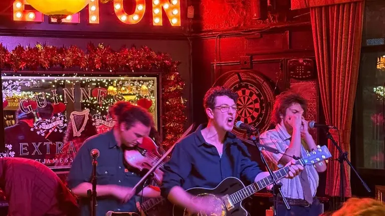 3 musicians on stage playing music